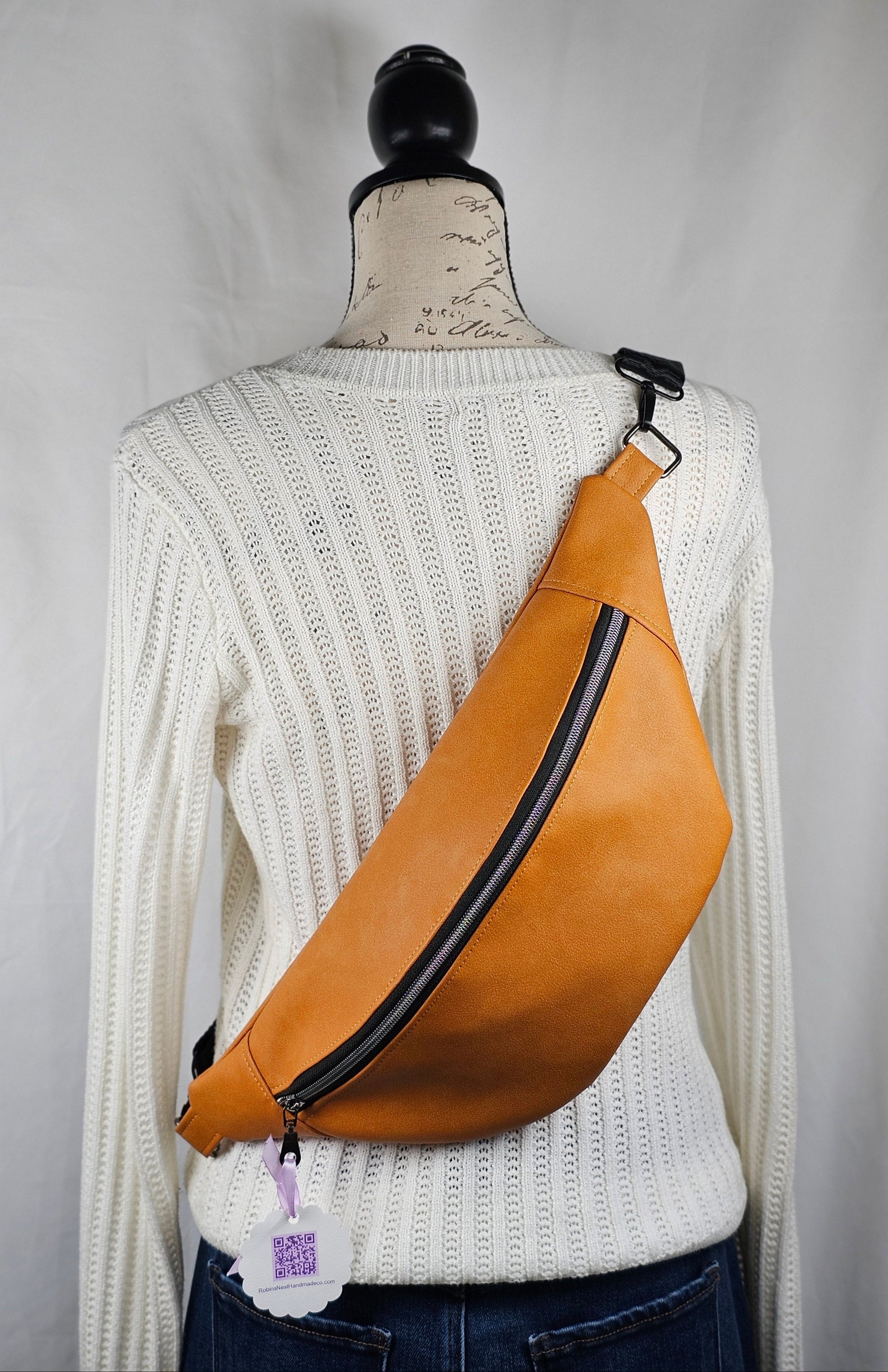 Pumpkin Spiced faux leather sling, fanny pack, bum bag with cat mugs printed on cotton fabric for interior. Interior Slip and zippered pocket. Black textured 1.5 inch strap with black zipper and gun metal hardware