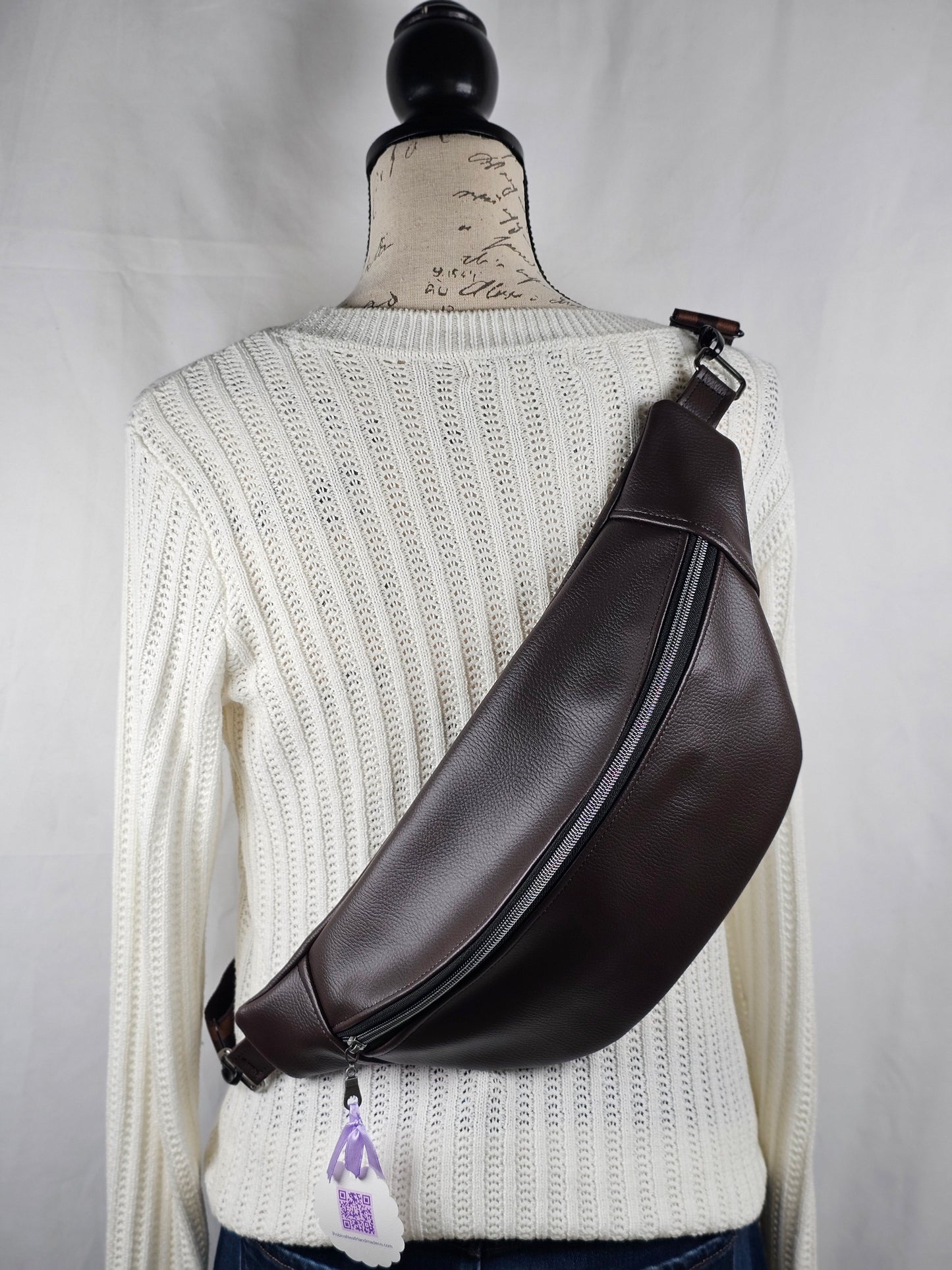brown faux  leather bag on a mannequin with a white background