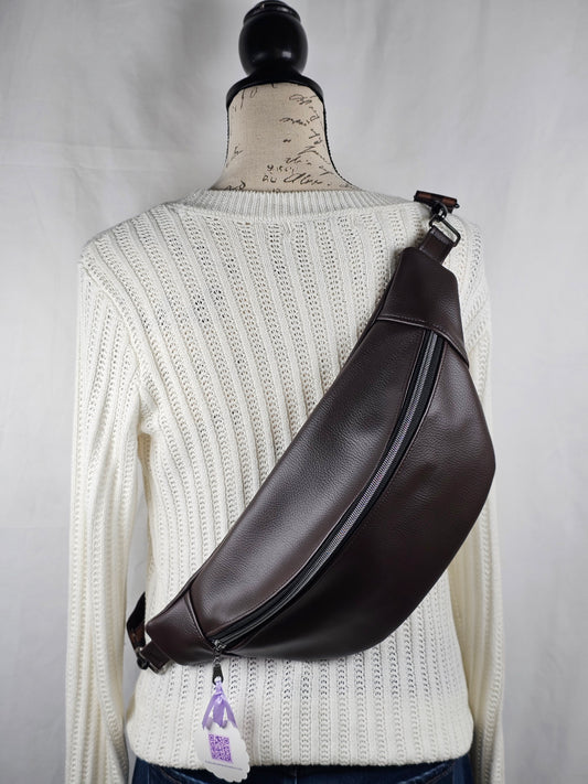 brown faux  leather bag on a mannequin with a white background