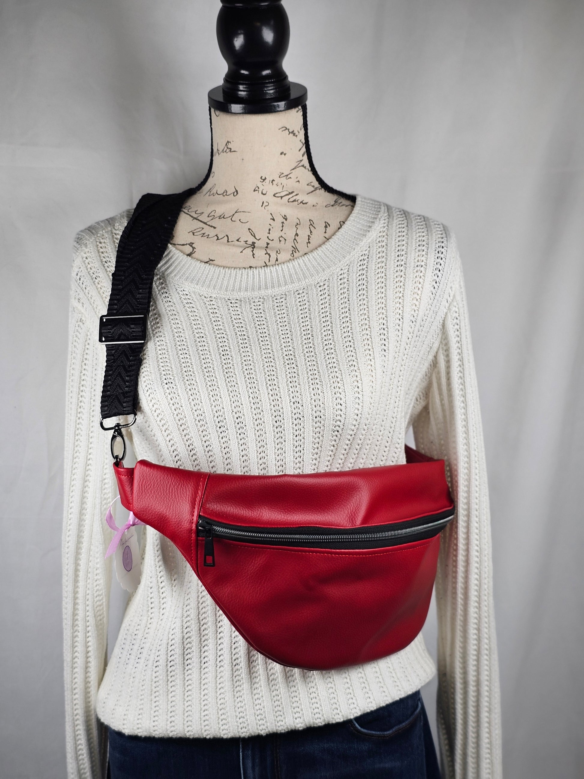 Red faux leather sling fanny pack with mushroom cotton lining and one slip pocket